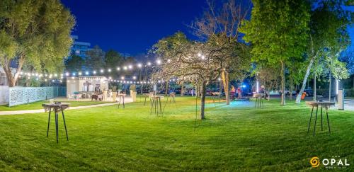 a park with trees and lights at night at Hotel Opal in Jupiter