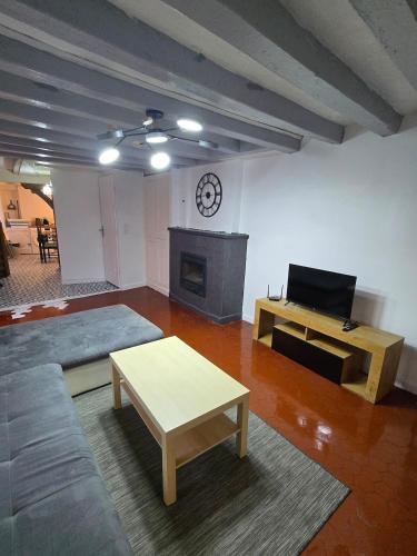 a living room with a couch and a fireplace at Maison de ville spacieuse in Valençay