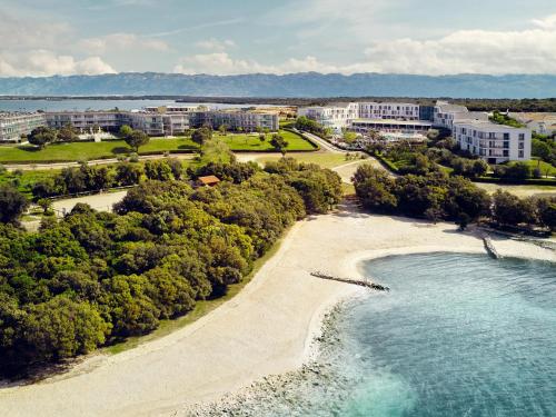 an aerial view of a beach with trees and buildings at Falkensteiner Family Hotel Diadora in Zadar