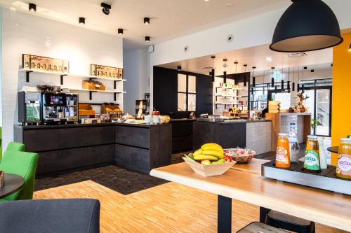 a kitchen with a counter with bananas on a table at De Brauhotel - Hôtel de la Brasserie Nationale in Bascharage