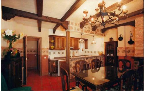 a large kitchen with a table in a room at Marqueño Turismo Rural in Vianos