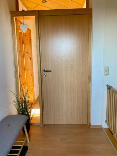 a wooden door in a room with a wooden floor at Ferienwohnung Louisa in Waldeck