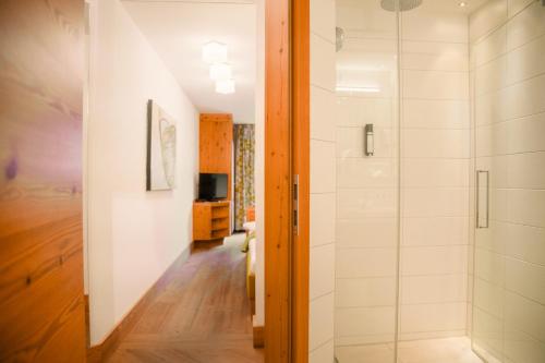 a bathroom with a shower and a walk in shower at Hotel Glemmtalerhof in Saalbach Hinterglemm