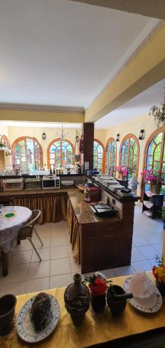 a large kitchen with many windows and tables in a room at شاطئ مونيكا in Mohammedia