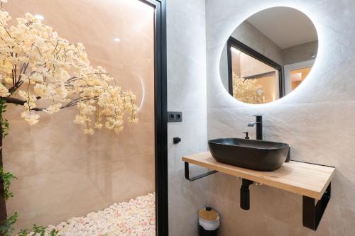a bathroom with a black sink and a mirror at Bilbao Loft Apartments in Bilbao
