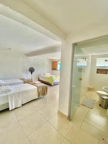 a hotel room with two beds and a bathroom at Casa Pedra da Canastra in São José do Barreiro