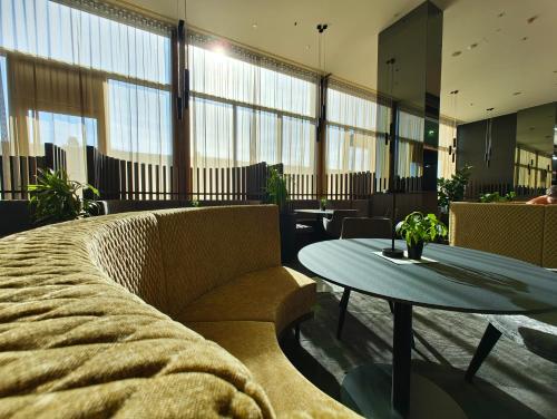 a living room with a couch and a table at Pannonia Tower in Parndorf