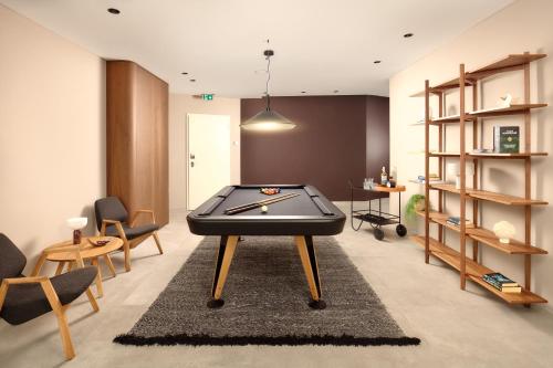 a living room with a pool table on a rug at Radisson Blu Resort & Spa in Split