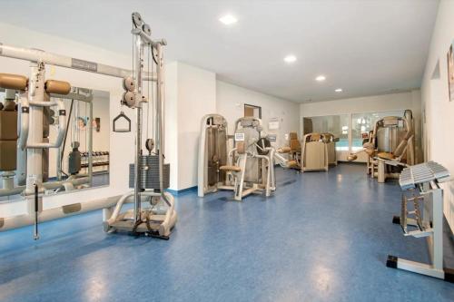 a gym with treadmills and machines in a room at Appartement Hella Wahnsinn in Sankt Englmar