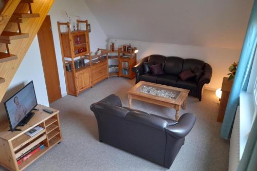 a living room with a couch and a coffee table at Haus Antje FW Meeresblick OG in Goting