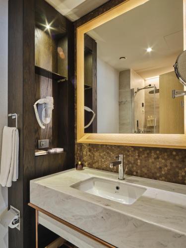 a bathroom with a sink and a mirror at Four-G Hotel Premium in Istanbul