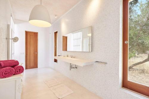 a bathroom with a sink and a mirror at Elegant Villa Retreat in Ibiza's Heart, 1041 in Sant Josep de Sa Talaia