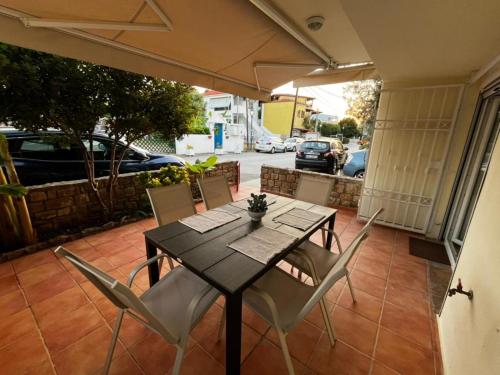 a dining table and chairs on a patio at Sirena Del Mar in Pefkohori