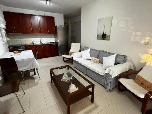 a living room with a couch and a table at Sirena Del Mar in Pefkohori