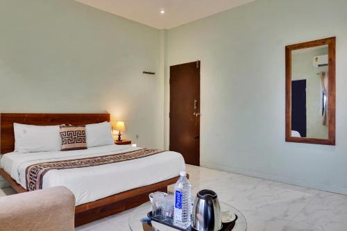a bedroom with a bed and a couch in a room at Hotel Sayba Classic in Pandharpur