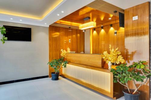 a lobby of a waiting room with plants at Hotel Sayba Classic in Pandharpur