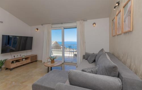 a living room with a couch and a large window at Villa Sestic-Makarska by Villas Guide in Tučepi
