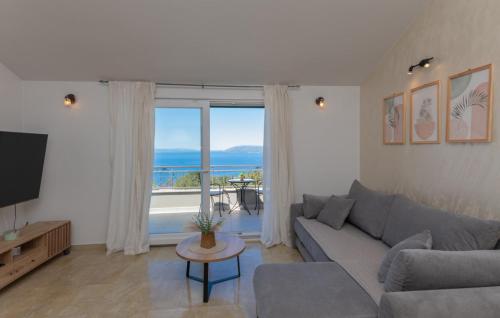 a living room with a couch and a large window at Villa Sestic-Makarska by Villas Guide in Tučepi