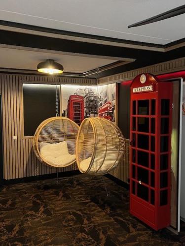 a room with two baskets and a red phone booth at Hotel The Happy Traveler in Groningen