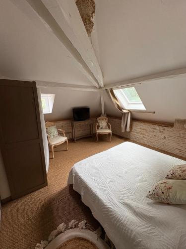 a bedroom with a bed and two windows at Chambre duo in Sainte-Gemme-la-Plaine