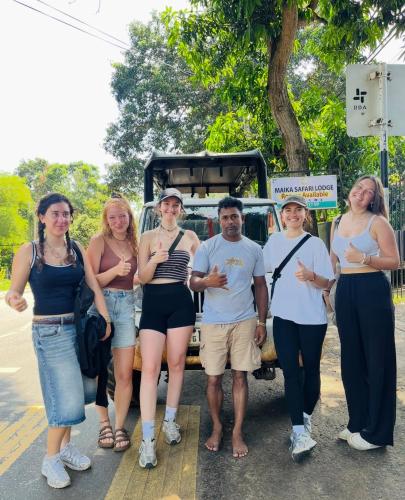 a group of people standing in front of a vehicle at Maika safari lodge in Udawalawe