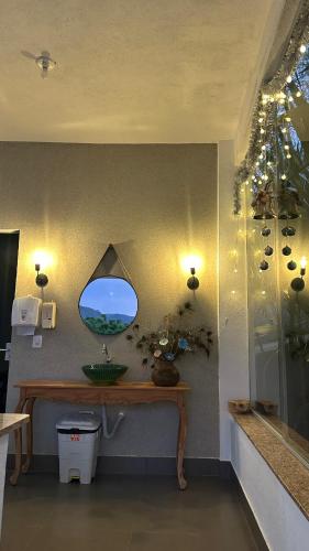 a bathroom with a mirror on the wall at Casa Pedra da Canastra in São José do Barreiro