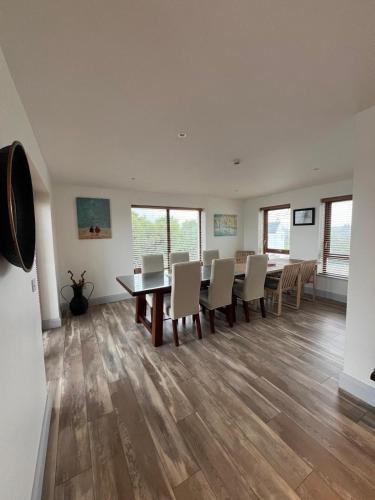 a dining room with a table and chairs at Unique Home with Outdoor Sauna in Connemara in Galway