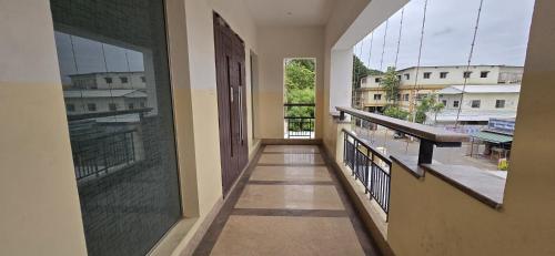 a hallway with a balcony with a view of a city at Heritage By High Point in Tiruchchirāppalli