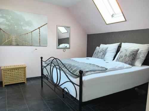 a bedroom with a large bed with a window at Ferienwohnungen Riedel in Pegnitz
