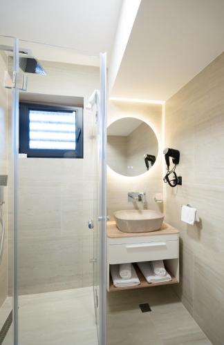 a bathroom with a sink and a shower at Hotel Spa Olive in Mostar