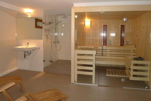 a bathroom with a shower and a toilet and a sink at Haus Westerheide in Nieblum
