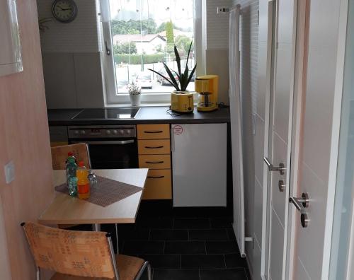 a small kitchen with a table and a window at Ferienwohnung in Rositz