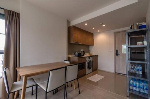a kitchen with a table and chairs in a room at Lacasita Penthouse Nap in Hua Hin