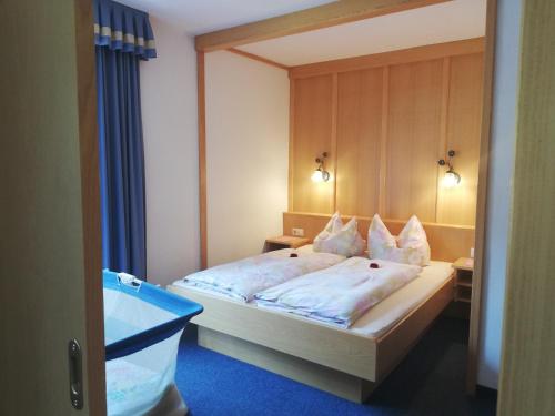 a bedroom with a bed and a tub in it at Gästehaus Sonja in Niederau