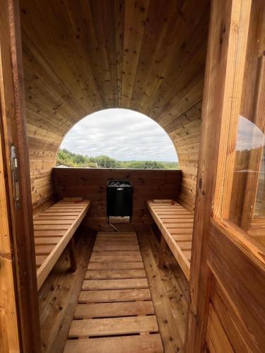 an inside view of a wooden sauna with a window at Unique Home with Outdoor Sauna in Connemara in Galway