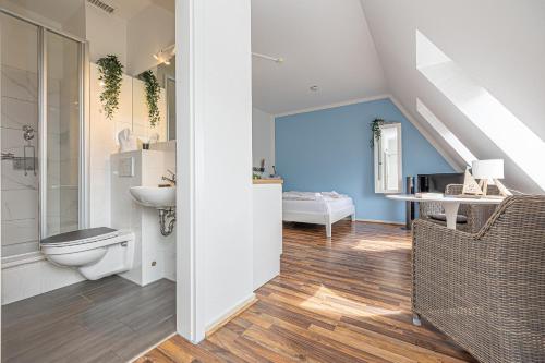 a bathroom with a toilet and a sink at fewo1846 - Strandresidenz Wassersleben AHOI - strandnahes Studioapartment im Dachgeschoss in Harrislee