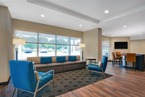 a living room with a couch and chairs and a table at TownePlace Suites by Marriott Sarasota/Bradenton West in Bradenton