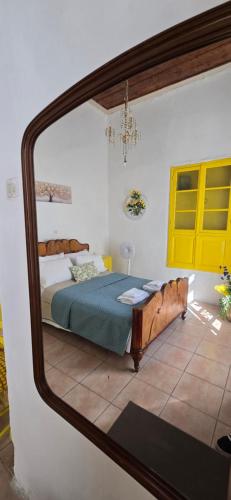 a bedroom with a bed and a mirror at Casa Violeta by 8essentially in Kefalás