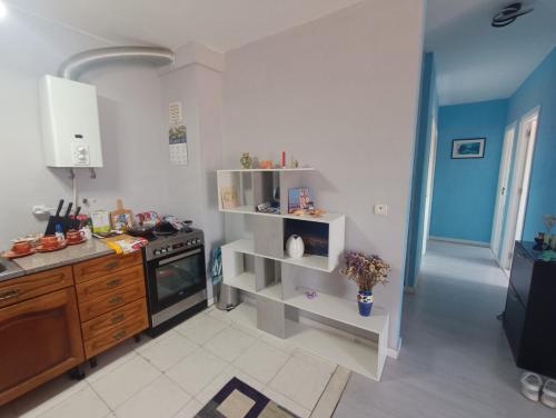 a kitchen with a sink and a stove top oven at Ocean view 2 bedroom flat in Setúbal