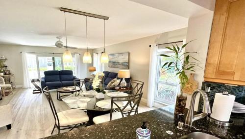 a kitchen and living room with a table and chairs at Just minutes from the beach Boca Raton in Boca Raton