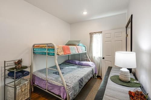 a bedroom with two bunk beds and a lamp at Less Than 2 Mi to Dtwn Pet-Friendly Getaway in Fairbanks in Fairbanks