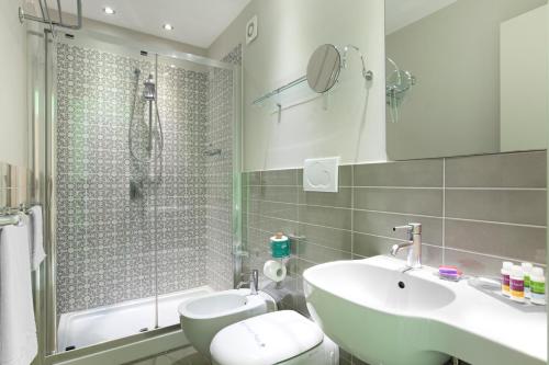 a bathroom with a sink and a toilet and a shower at Palazzo Tasso in Sorrento