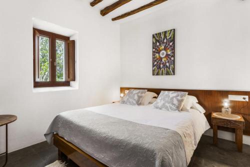 a white bedroom with a large bed and a window at Luxury 9 Bedroom Villa in Ibiza City, 1250 in Sant Carles de Peralta