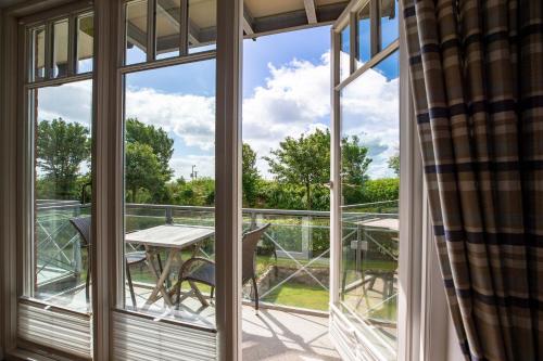 a view from the balcony of a house with a table and chairs at Haus Leuchtfeuer 4 in Wyk auf Föhr