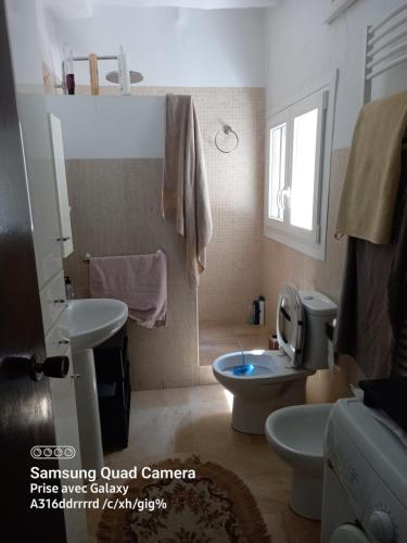 a bathroom with a toilet and a sink at Casa De Giulio in Cocentaina