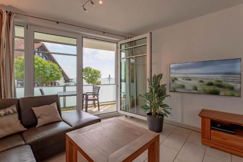 a living room with a couch and a table at Schloss am Meer 9 in Wyk auf Föhr