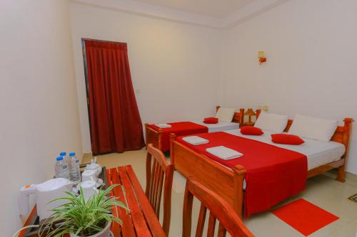a bedroom with a bed and a table with a red blanket at Castle Resort Yala in Tissamaharama