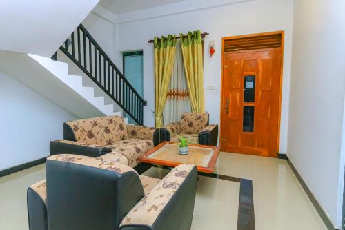 a living room with chairs and a table and a staircase at Castle Resort Yala in Tissamaharama