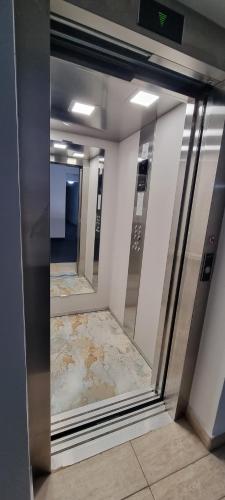 a reflection of a hallway with mirrors in a building at Hotel Blue Sky Resort in Eforie Nord