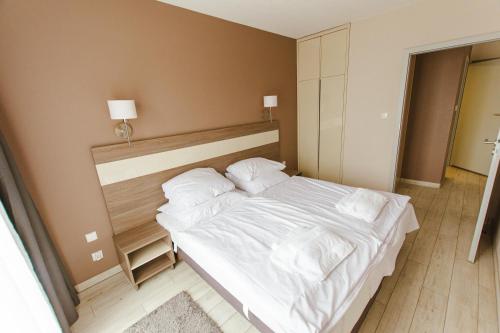 Giường trong phòng chung tại VacationClub - BORMIO Apartament 29